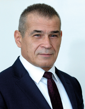 Elegáns öltönyös férfi Elegáns öltönyben lévő férfi, fehér inggel és sötét nyakkendővel.