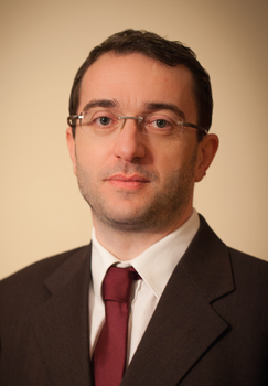 Formális öltözet sötét öltönyben, fehér inggel és bordó nyakkendővel