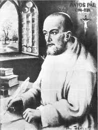 Ányos Pál szerzetes írás közben, háttérben táj Ányos Pál szerzetes írással foglalkozik egy asztalnál, háttérben táj látható.