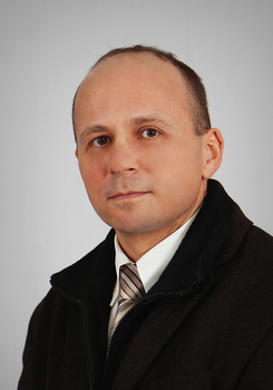 Formális öltözet, amely sötét kabátot, fehér inget és csíkos nyakkendőt tartalmaz.