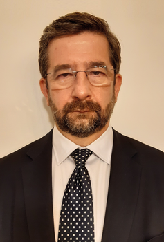 Formális öltözet sötét öltönyben és fehér ingben Sötét öltöny, fehér ing és mintás nyakkendő formális öltözetben