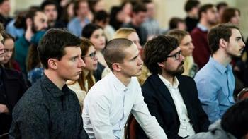 Emberek egy rendezvényen vagy előadáson Csoport ember ül egy rendezvényen vagy előadáson, figyelmesen hallgatva.